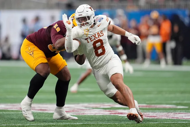 Jan 1, 2025; Atlanta, GA, USA; Texas Longhorns linebacker Trey Moore (8) runs around Arizona State Sun Devils offensive lineman Max Iheanachor (58) during the first half of the Peach Bowl at Mercedes-Benz Stadium. Mandatory Credit: Dale Zanine-Imagn Images