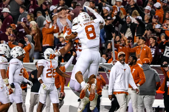 Nov 30, 2024; College Station, Texas, USA; Texas Longhorns edge rusher Trey Moore (8)and defensive lineman Alfred Collins (95) celebrate a defensive stop during the Lone Star Showdown against the Texas A&M Aggies at Kyle Field. Mandatory Credit: Sara Diggins/USA TODAY Network via Imagn Images