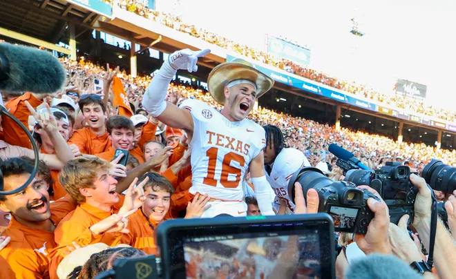 Oct 12, 2024; Dallas, Texas, USA; Texas Longhorns defensive back Michael Taaffe (16) celebrates with fans after the game against the Oklahoma Sooners at the Cotton Bowl. Mandatory Credit: Kevin Jairaj-Imagn Images