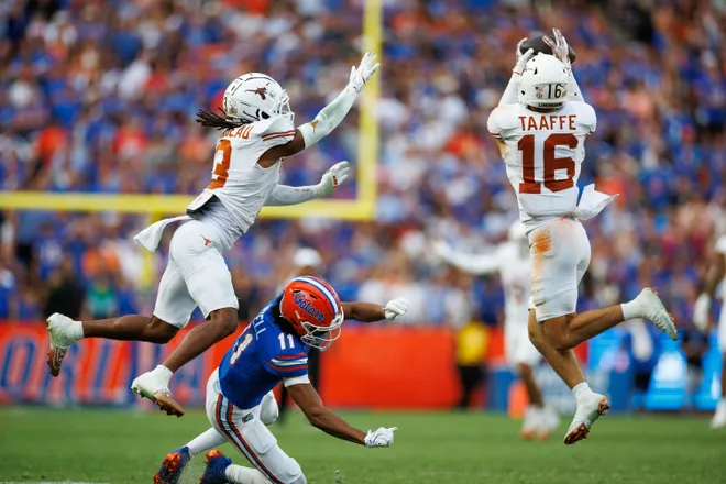 Oct 4, 2025; Gainesville, Florida, USA; Texas Longhorns defensive back Michael Taaffe (16) intercepts a pass to Florida Gators wide receiver Aidan Mizell (11) during the second half at Ben Hill Griffin Stadium. Mandatory Credit: Matt Pendleton-Imagn Images
