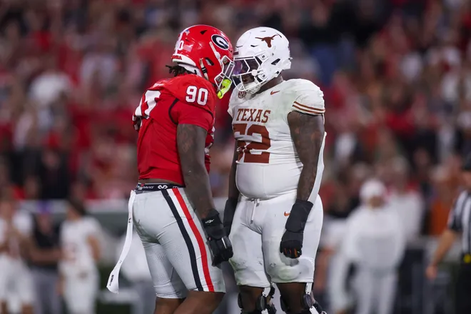 Nov 15, 2025; Athens, Georgia, USA; Georgia Bulldogs defensive lineman Elijah Griffin (90) and Texas Longhorns offensive lineman DJ Campbell (52) interact in the second half at Sanford Stadium. Mandatory Credit: Brett Davis-Imagn Images