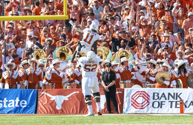 Oct 12, 2024; Dallas, Texas, USA; Texas Longhorns wide receiver Silas Bolden (11) celebrates a touchdown with Texas Longhorns offensive lineman DJ Campbell (52) during the first half against the Oklahoma Sooners at the Cotton Bowl. Mandatory Credit: Kevin Jairaj-Imagn Images