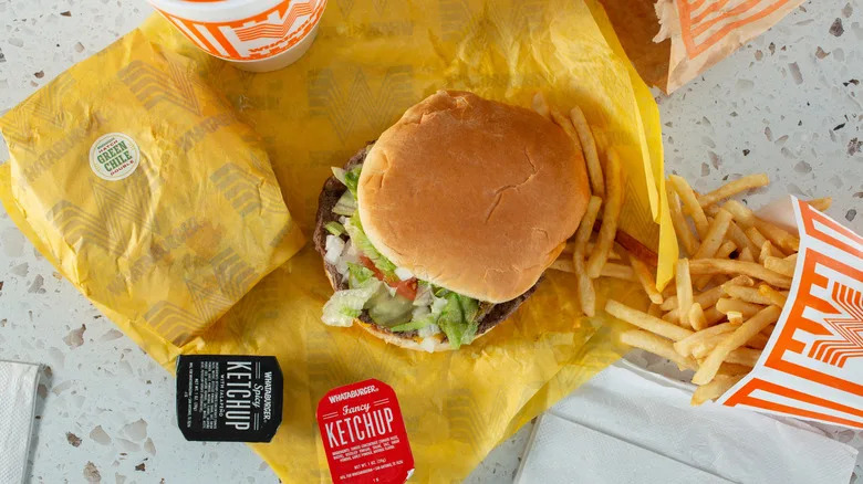 Whataburger meal with burger, fries, drink, and sauces.