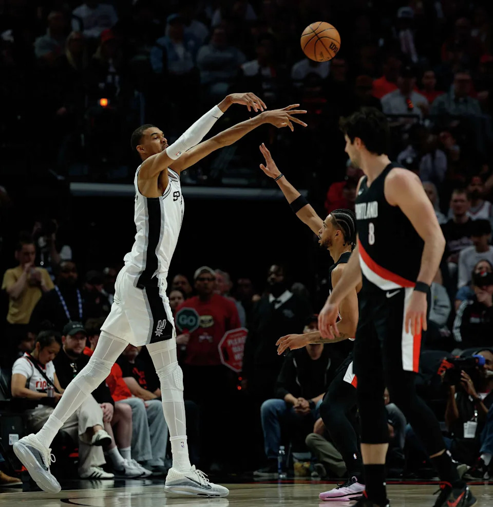 San Antonio Spurs forward Victor Wembanyama (1) makes a pass over Portland Trail Blazers forward <a class="link " href="https://sports.yahoo.com/nba/players/10065/" data-i13n="sec:content-canvas;subsec:anchor_text;elm:context_link" data-ylk="slk:Toumani Camara;sec:content-canvas;subsec:anchor_text;elm:context_link;itc:0" data-yga="{"yLinkElement":"context_link","yModuleName":"content-canvas","yLinkText":"Toumani Camara","ySubModuleName":"anchor_text","yHasCommerce":false}">Toumani Camara</a> (33) during the third quarter of Game 4 of a first-round NBA playoff series at Moda Center on Sunday, April 26, 2026. (Sam Owens/San Antonio Express-News)