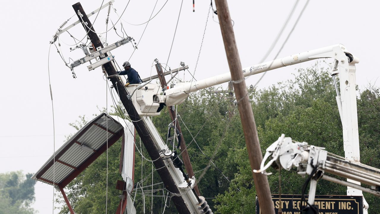 A lineman works to repair a damaged power pole after severe weather hit the area, Sunday, April 26, 2026, in Springtown, Texas. (Elías Valverde II/The Dallas Morning News via AP)