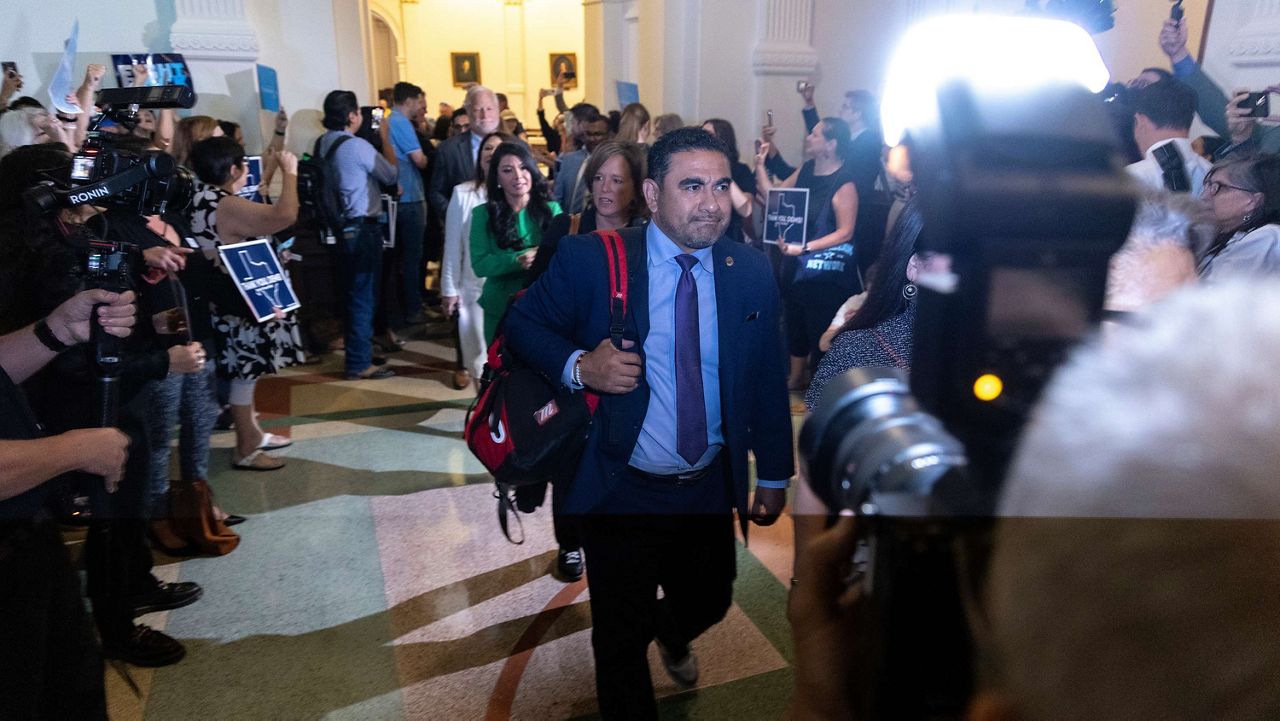 Texas State Rep. Armando Walle enters the house chambers at the Texas Capitol in Austin, Texas, Tuesday, Aug. 18, 2025. (AP Photo/Stephen Spillman)