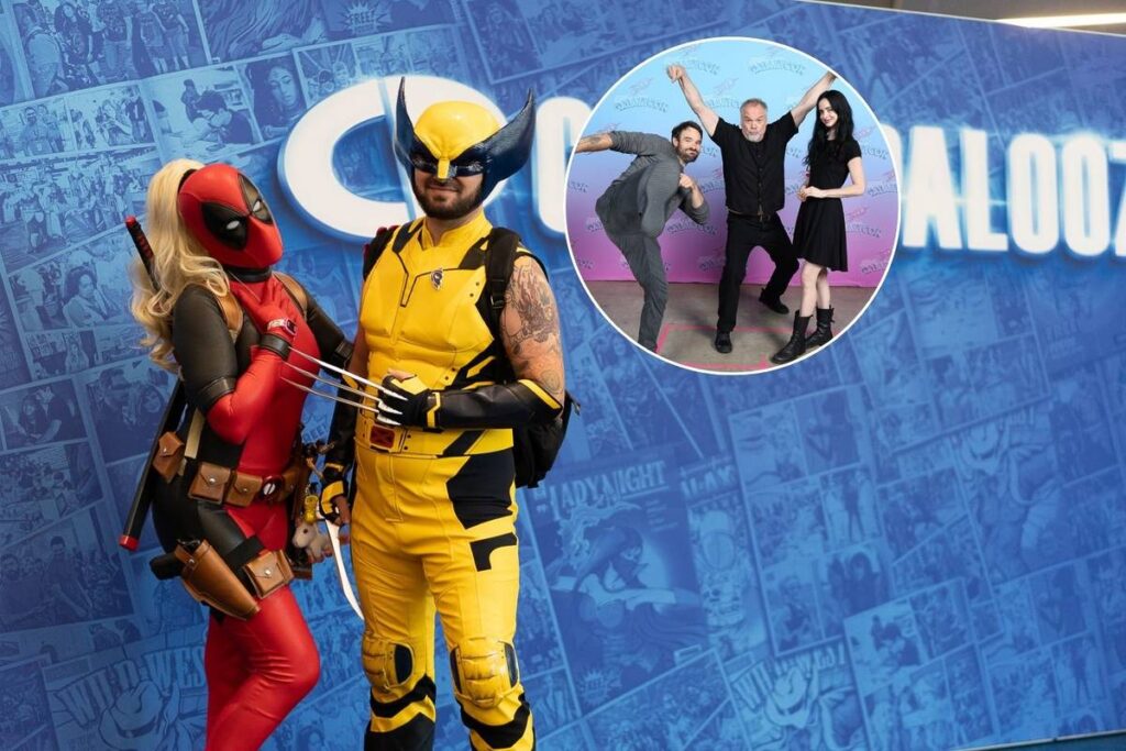 Image shows two cosplayers dressed up as a woman Deadpool character and Wolverine character posing in front of the Comicpalooza banner.