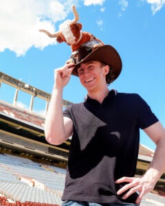 image of a student with a Bevo stuffed animal on a cowboy hat