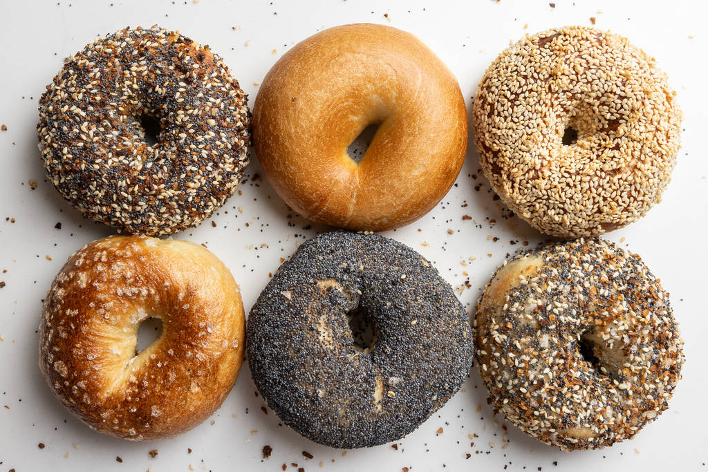 Image shows a selection of six bagels as served by PopUp Bagels. 