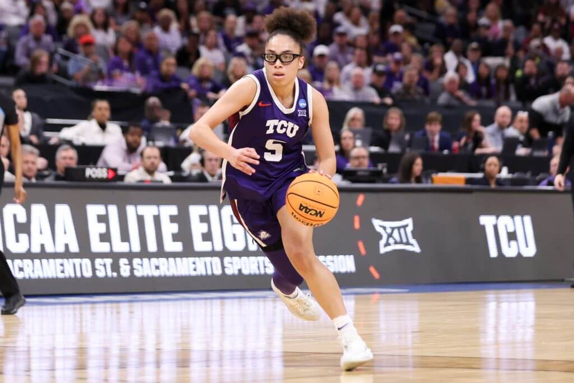 Olivia Miles dribbles the ball down the court.