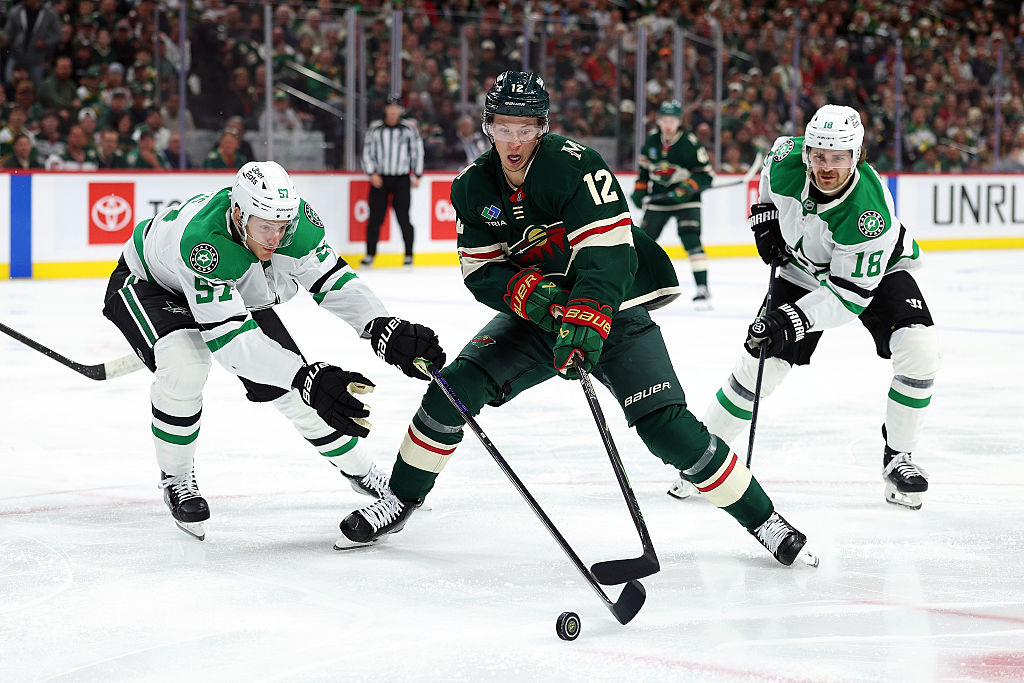 ST PAUL, MINNESOTA - APRIL 22: Matt Boldy #12 of the Minnesota Wild skates with the puck against Tyler Myers #57 and Sam Steel #18 of the Dallas Stars in the second period of Game Three of the First Round of the 2026 Stanley Cup Playoffs at Grand Casino Arena on April 22, 2026 in St Paul, Minnesota. (Photo by David Berding/Getty Images)