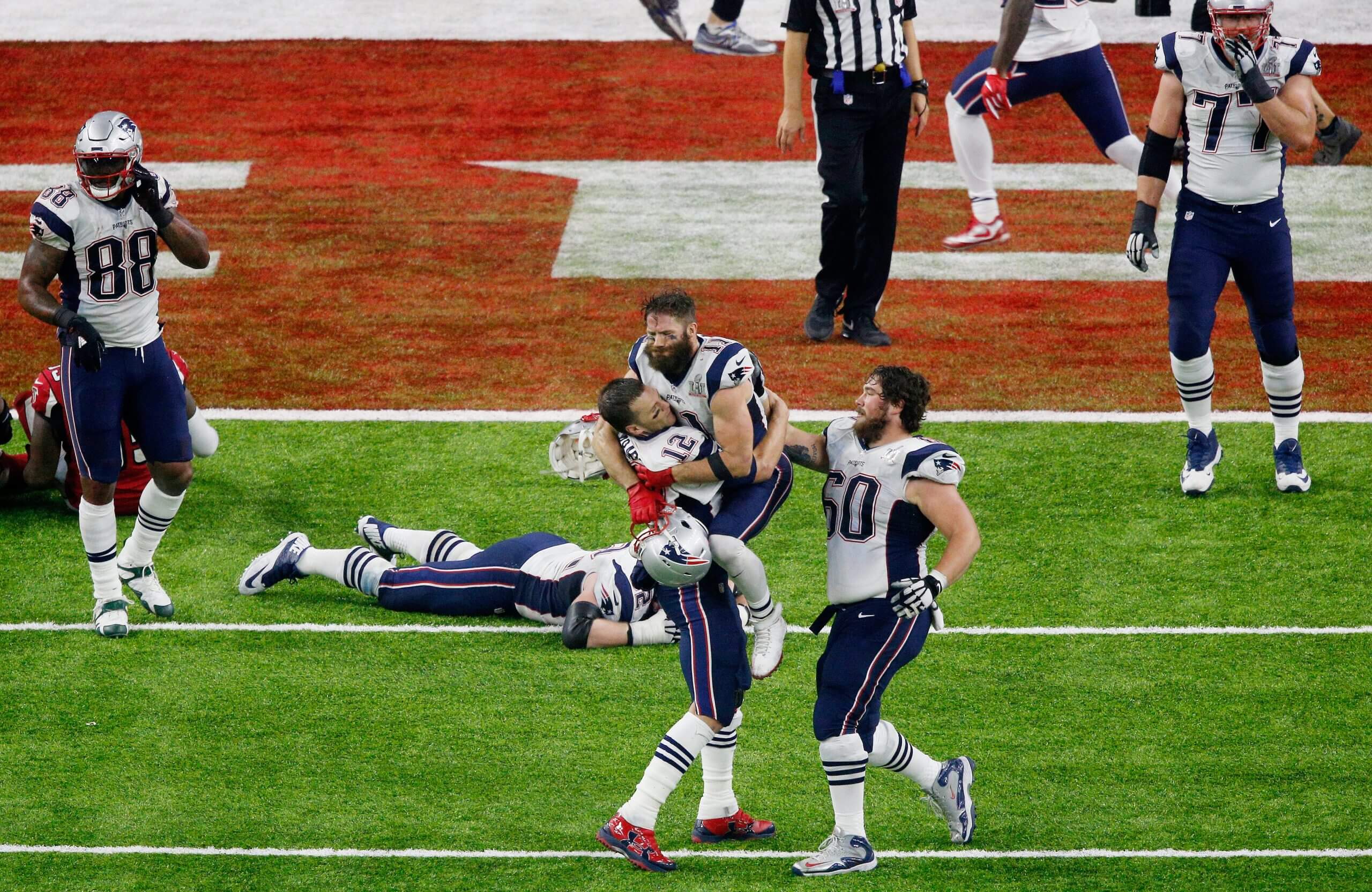 Tom Brady picks up teammate Julian Edelman after the New England Patriots defeated the Atlanta Falcons 34-28 in overtime during Super Bowl LI at NRG Stadium