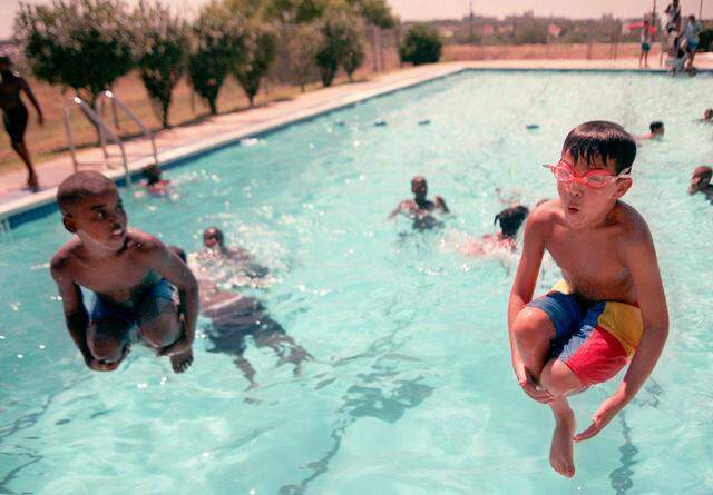 July 27, 1999: Tony Austin, 8, and Gustavo Cervantes, 11, cool off in the pool at McDonald YMCA in Fort Worth.