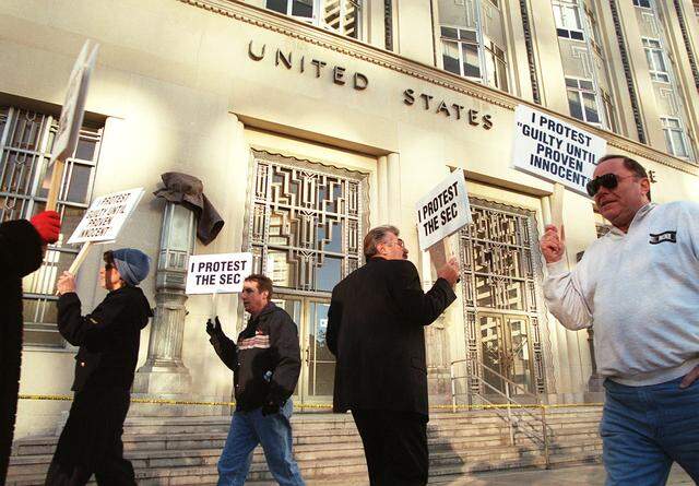 Dec. 6, 1999: Gary Reeder, center, and his wife Sandra, far left, are joined by clients of Cornerstone Prodigy outside the U.S. Courthouse in downtown Fort Worth as they protest against the Securities and Exchange Commission. The commission filed suit against Cornerstone Prodigy. The company's assets and Reeder's home were seized. Protesters voiced their support for Reeder and said they had faith in the company.