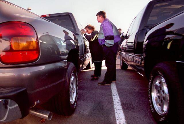 Dec. 27, 1999: Shopping for a new truck are Roger Ivy and Eva Ivy, from Parker County (they work in Fort Worth). They are looking at a half-ton pickup at Troy Aikman Auto Mall.