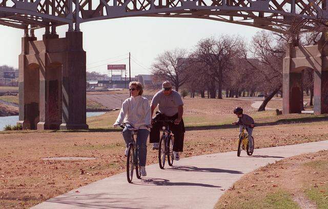 Vicki Holland and Stan Holland, along with Cody Moon, 7, enjoy their New Year's Day bike ride at Trinity Park in Fort Worth. 