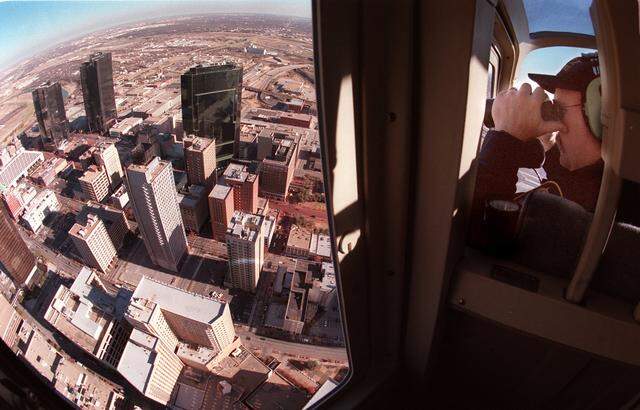 Fort Worth Police Department Flight Officer Larry Henderson keeps watch above downtown Forth Worth while patrolling aboard Air One Friday morning. Photo made at10:45 AM. (Star Telegram/ Ron J. Jenkins) 12/31/99