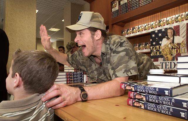 Aug. 23, 2000: Musician and writer Ted Nugent mugs for a camera along with a young fan Tyler Barbare, 7, during Nugent's book signing at Barnes and Noble in downtown Fort Worth.