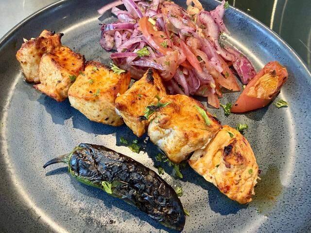 Chicken kebab with garnish and a grilled jalapeño at Beren Meze & Grill House.