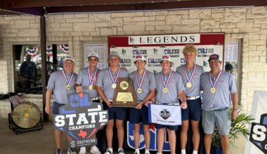 Seven young golfers in gray shirts with gold medals pose together in front of a Legends State Championships banner, holding a large trophy and banners.