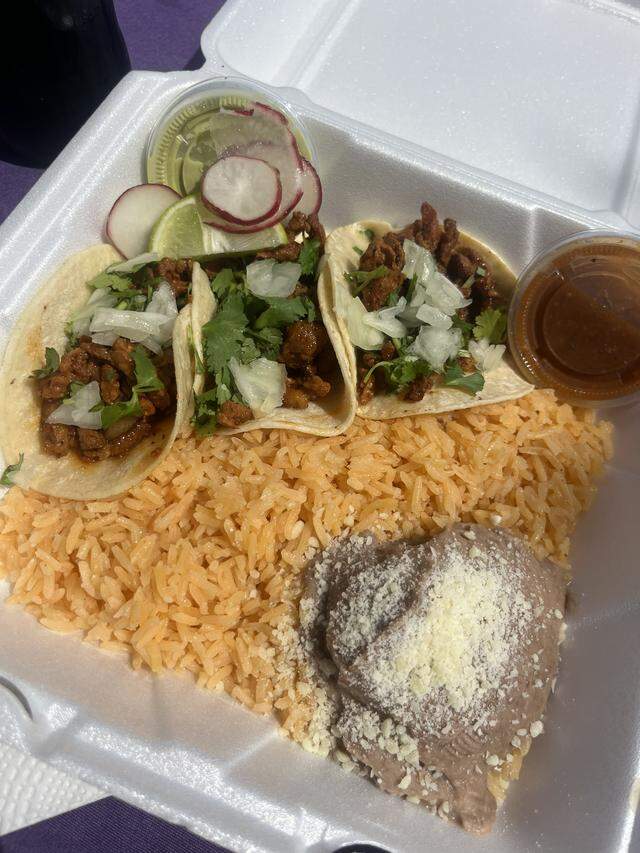 Three El Pastor tacos with rice and beans from Super Taco Food Truck in north Fort Worth. This food truck offer $1 taco Tuesdays.