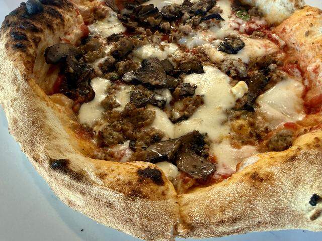 A sausage-and-mushroom pizza at Acquario Pizza Pasta + Bar in Keller, Texas, seen March 2, 2026.