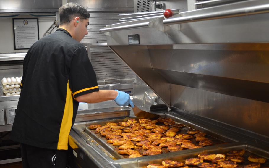 Villalobos monitors as chicken fills the grill.