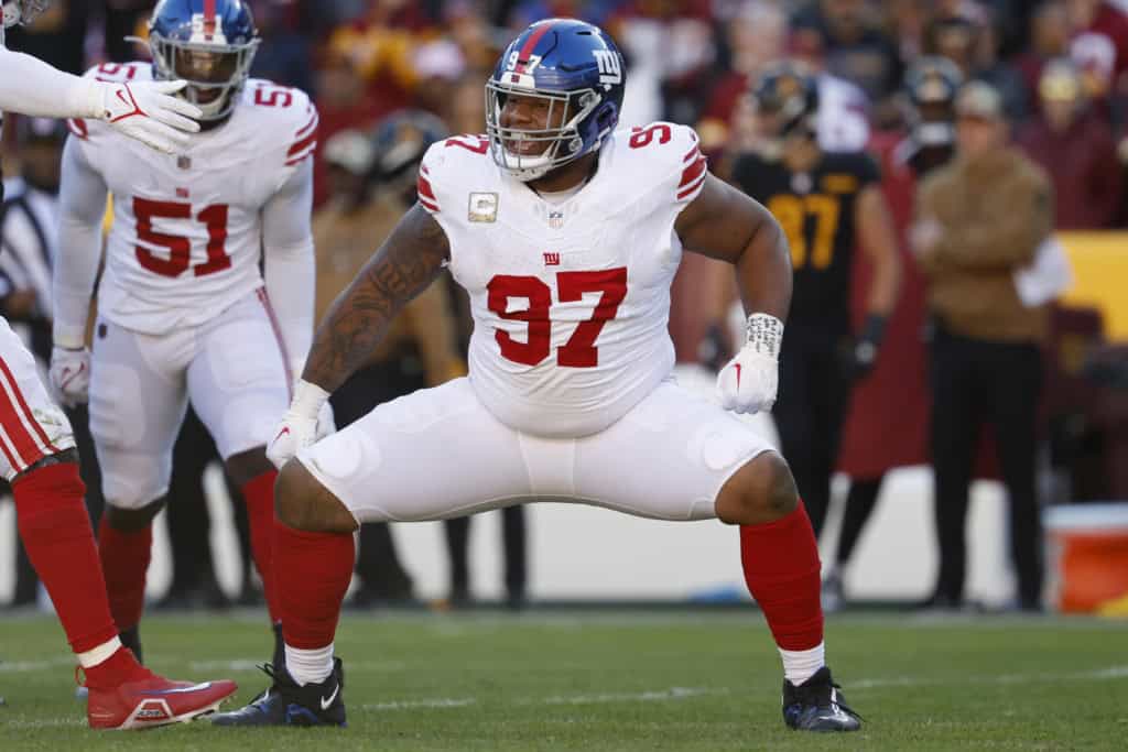 Dexter Lawrence reacts during a game in a white New York Giants road uniform as he moves across the field.