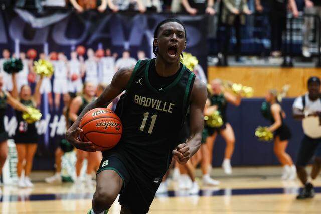 Birdville guard DJ Driver screams in celebration after the Hawks defeated Denton 50-49 in a Class 5A Division I regional final March 6 at Flower Mound.