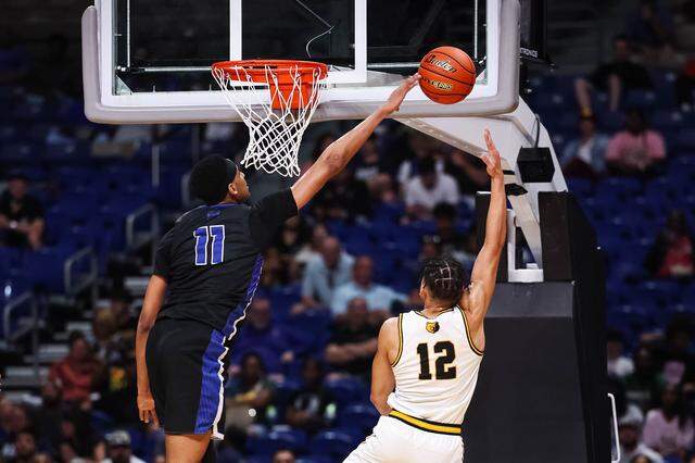 North Crowley forward Trey Hall blocks a shot from a San Antonio Brennan player in the Class 6A Division I state championship game March 14 at the Alamodome in San Antonio.