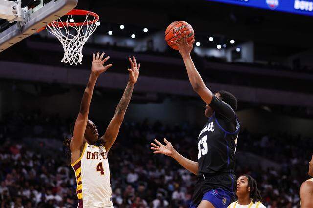 Mansfield Summit guard Javon Ross goes up for a layup over the arms of a Beaumont United defender in the Class 5A Division II state championship game March 14 at the Alamodome in San Antonio.