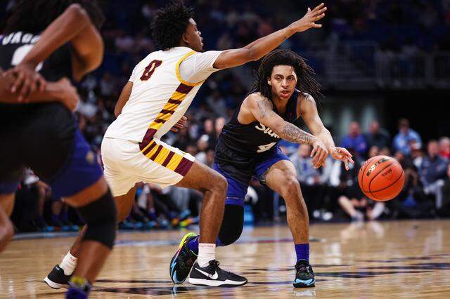 Mansfield Summit guard Jaxon Sneed makes a pass as a Beaumont United defender reaches his hand out in the Class 5A Division II state championship game March 14 at the Alamodome in San Antonio.