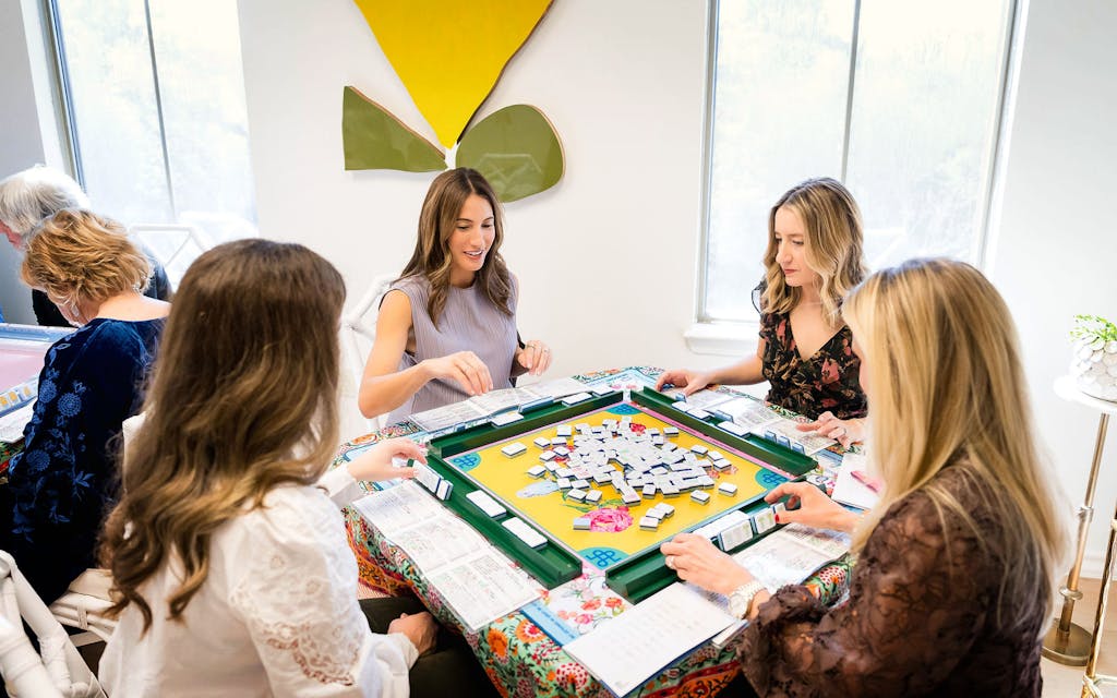 Mahj House co-founders Tara Young (center) and Courtney Harvey (right) play mahjong at their Austin location.
