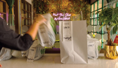 take out bags sitting on a counter, one is being removed.