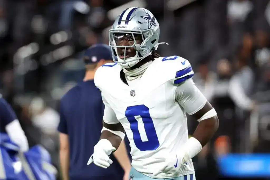 Could These 2 Sleepers Fix Dallas' Linebacker Depth? Dallas Cowboys linebacker DeMarvion Overshown warms up in a white road uniform before a game, wearing No. 0 and a silver helmet on the field.