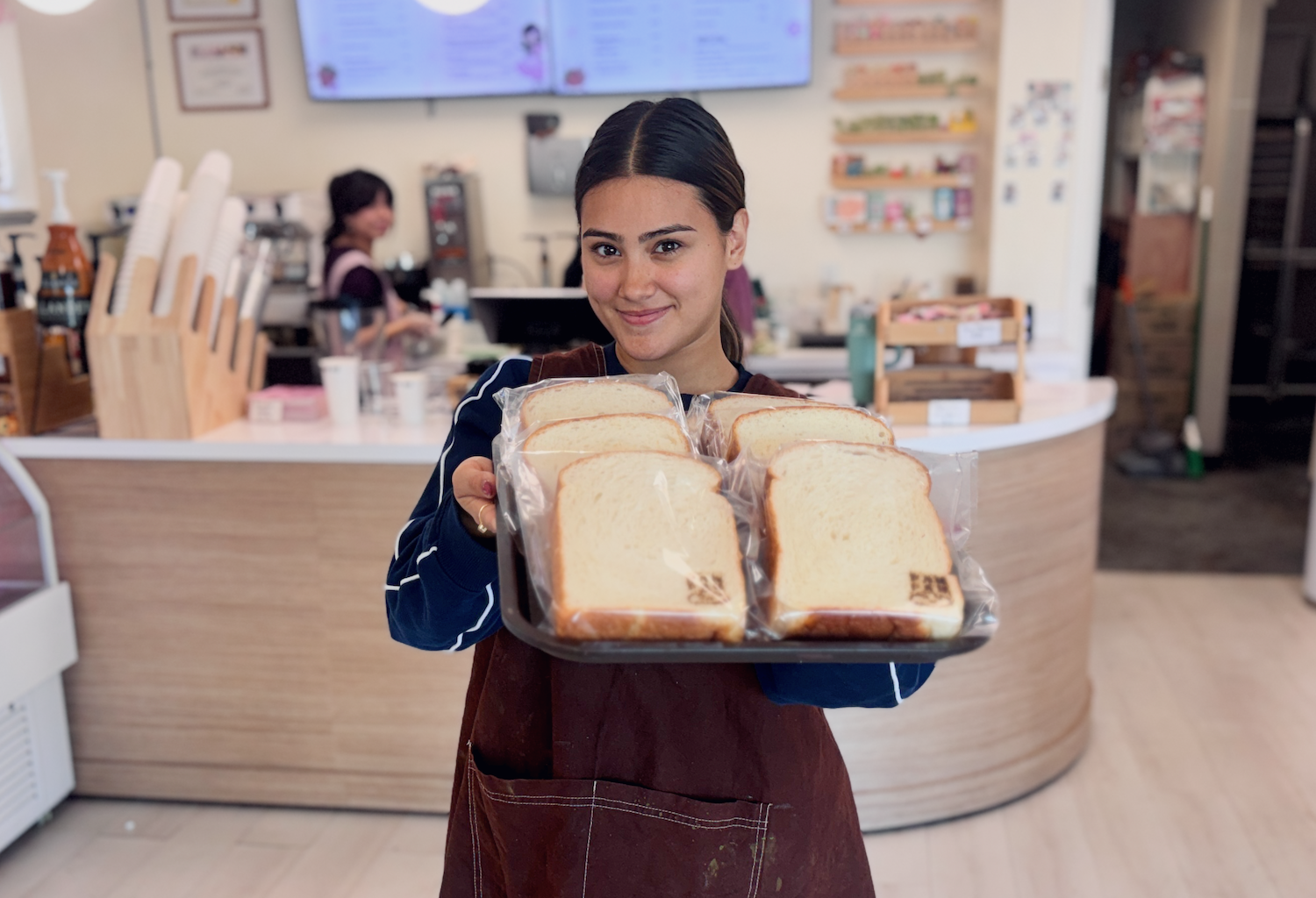 PanPan owner Laura Molinar showing off a pan of her soft bread.