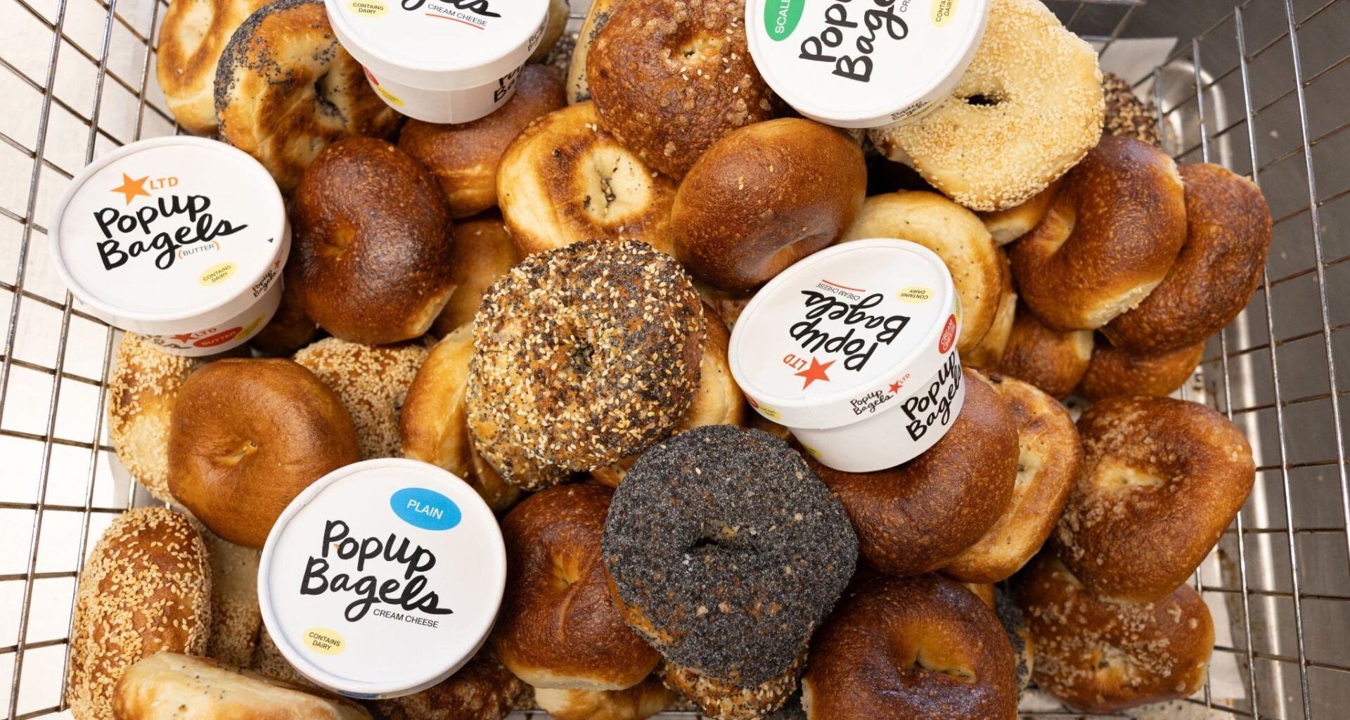 a basket of bagels and schmear from PopUp bagels