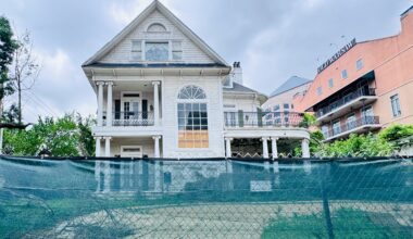 The hotel St. Germain in disrepair with a green construction fense around it.