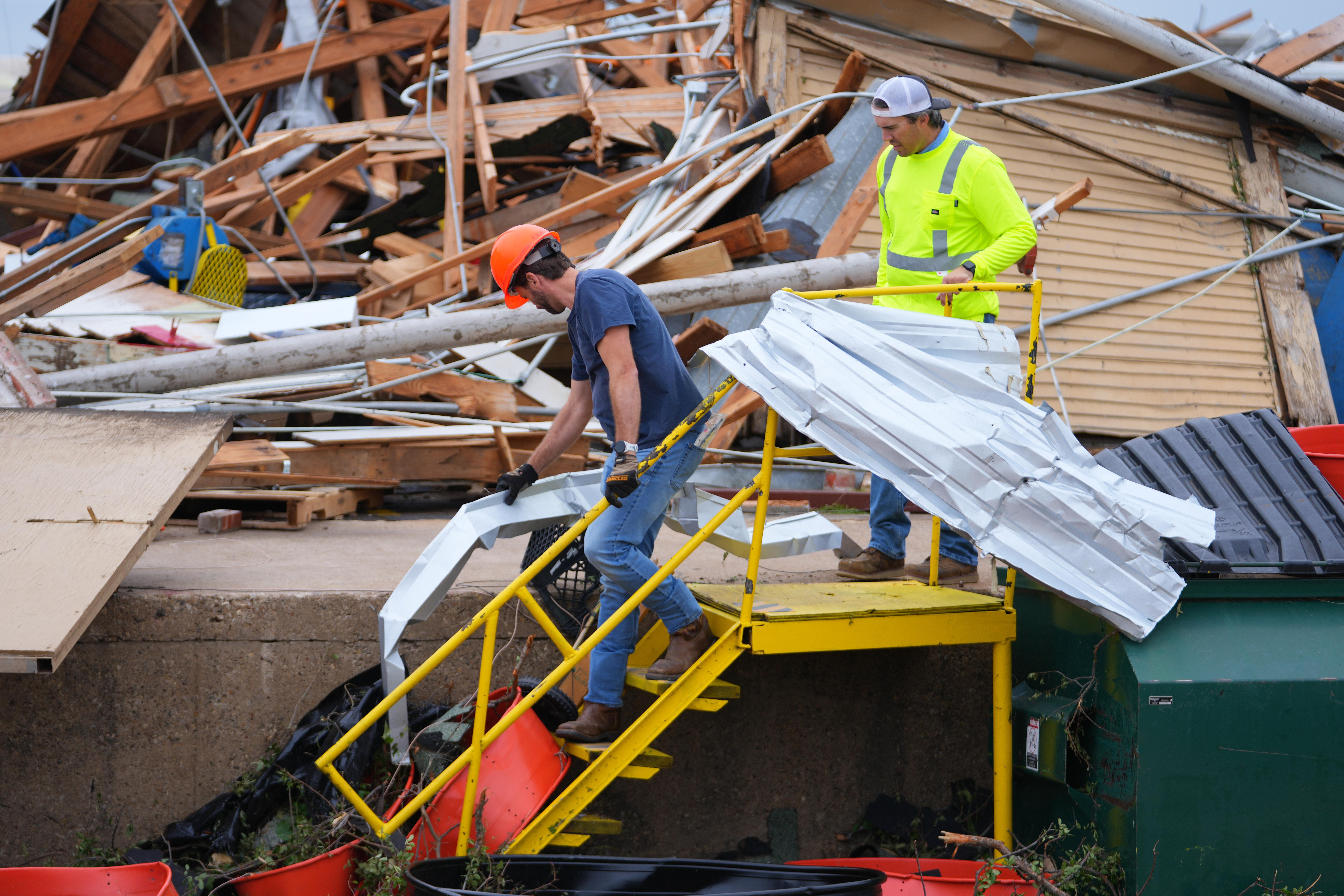 People clear debris following a storm in Mineral Wells, Texas,...