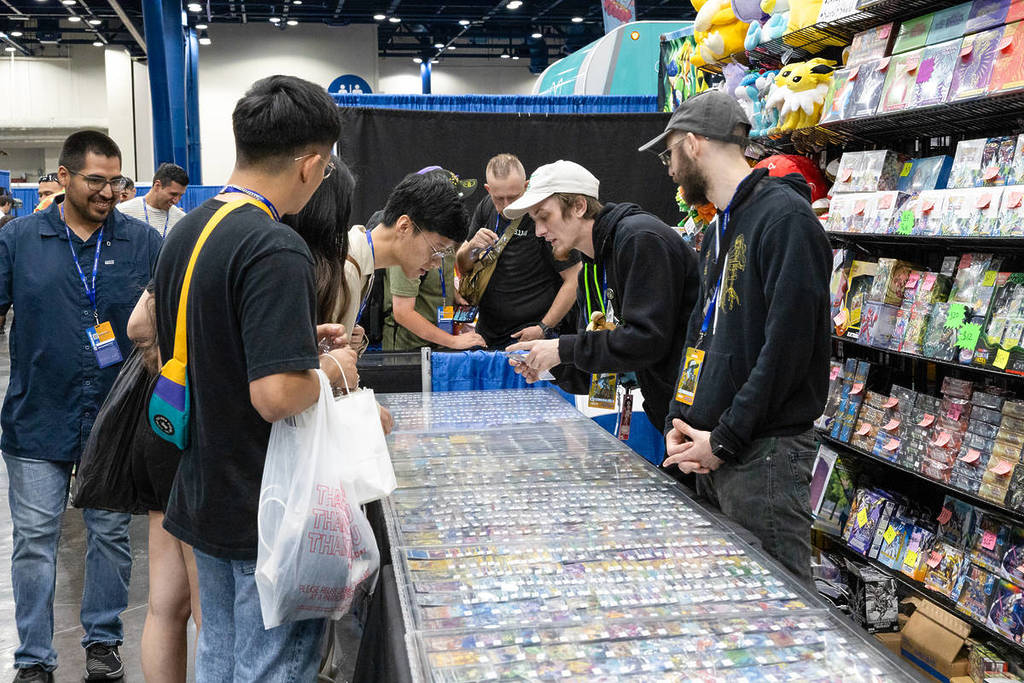 Image shows attendants of Comicpalooza in Houston visiting a booth. 