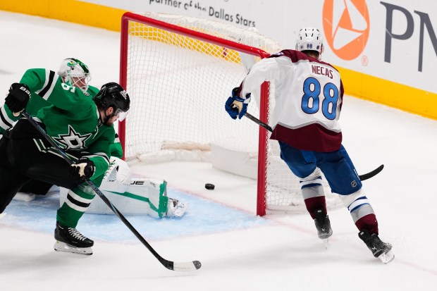 Colorado Avalanche center Martin Necas (88) scores against Dallas Stars' Casey DeSmith, left rear, as Lian Bichsel (6) looks on in the third period of an NHL hockey game Saturday, April 4, 2026, in Dallas. (AP Photo/Tony Gutierrez)