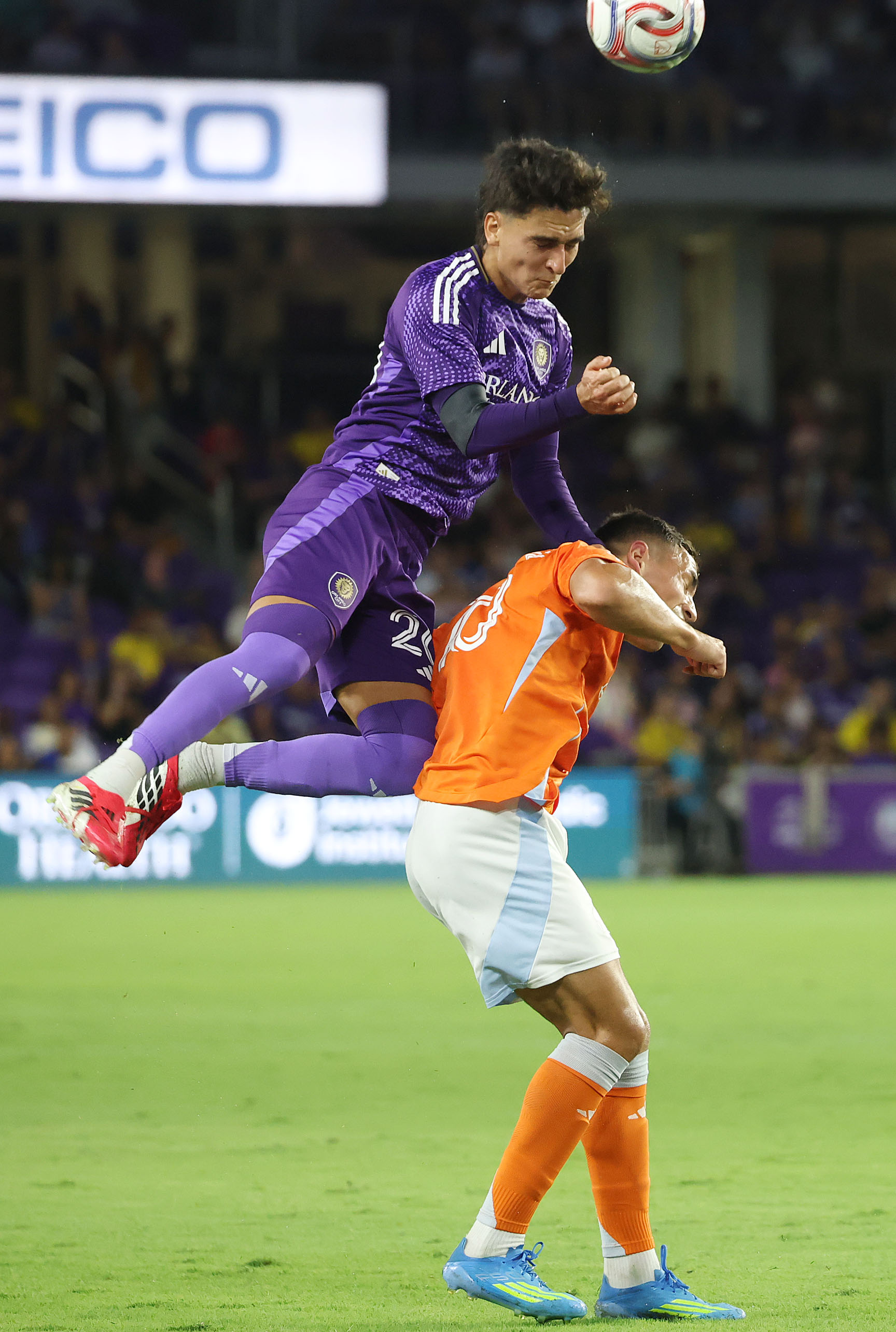 Orlando player Eduard Atuesta (top) leaps over Houston player Ezequiel...