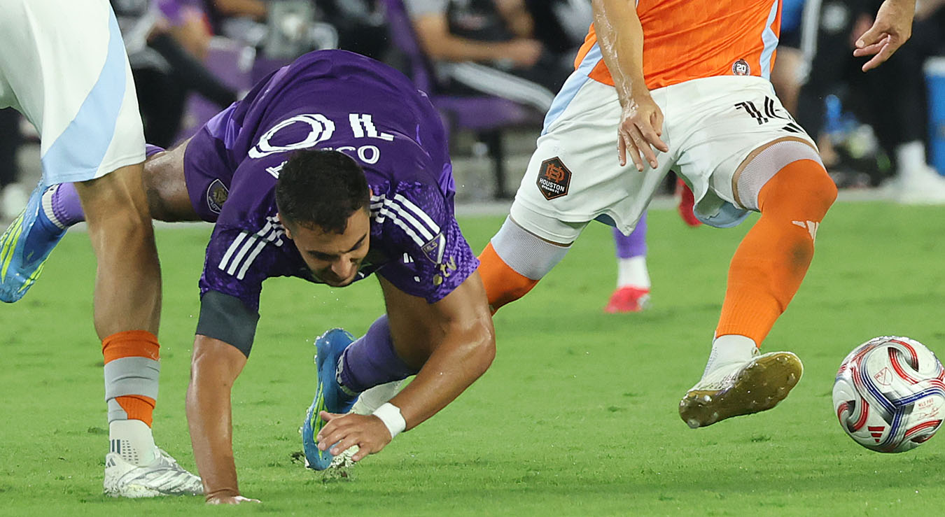 Orlando player Martin Ojeda (10) falls during the Houston Dynamo...