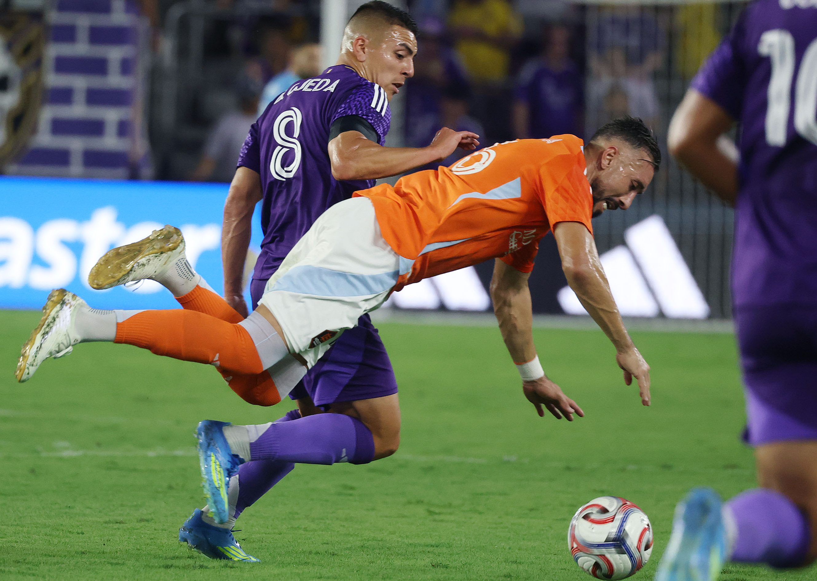 Orlando player Braian Ojeda (8) and Houston player Hector Herrera...