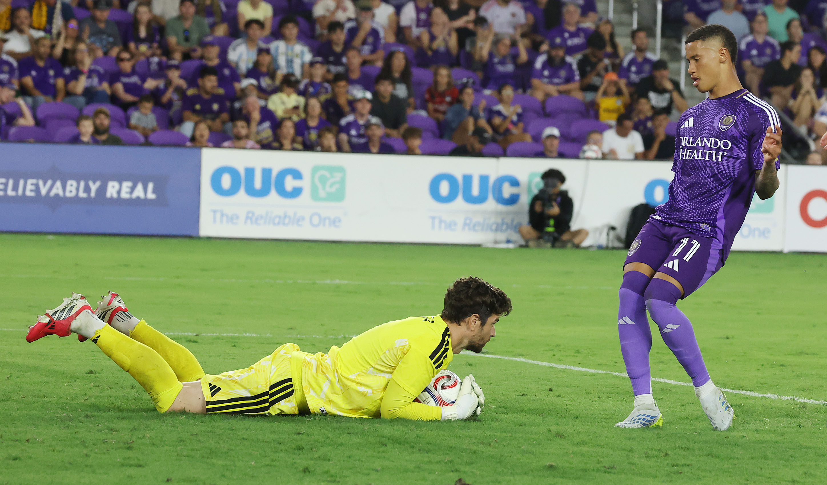 Houston goalkeeper Jimmy Maurer (left) stops the ball in front...