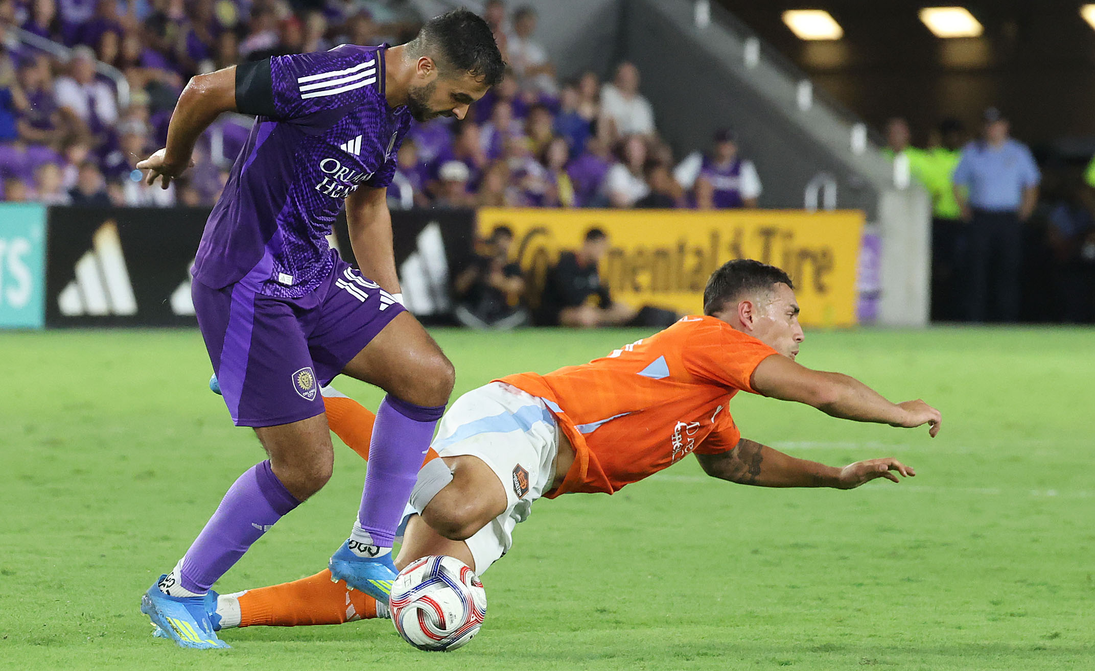 Orlando player Martin Ojeda (left) controls the ball beside falling...