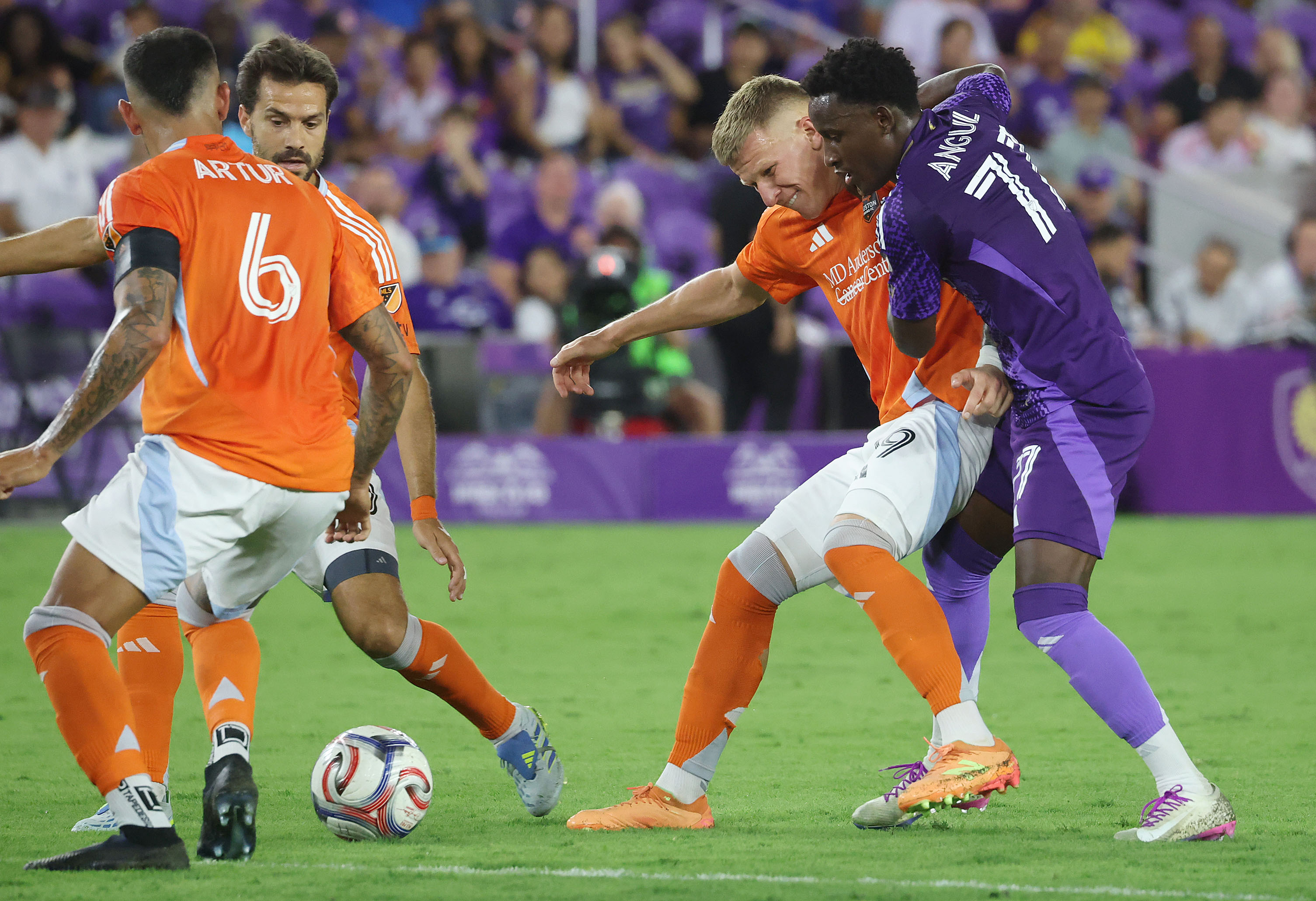 Orlando player Ivan Angulo (77) tries to take the ball...