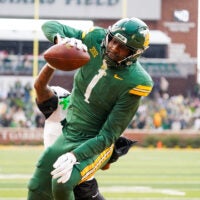 Nov 1, 2025; Waco, Texas, USA; Baylor Bears tight end Michael Trigg (1) catches a touchdown pass as UCF Knights defensive back Braeden Marshall (4) defends during the first half at McLane Stadium.