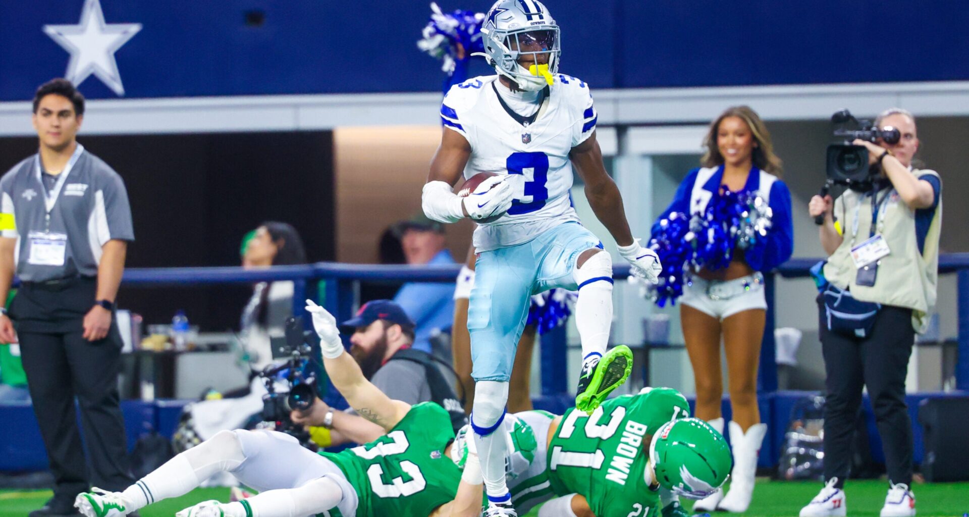 Nov 23, 2025; Arlington, Texas, USA; Dallas Cowboys wide receiver George Pickens (3) reacts after making a catch over Philadelphia Eagles cornerback Cooper DeJean (33) and Philadelphia Eagles safety Sydney Brown (21) during the game at AT&T Stadium.
