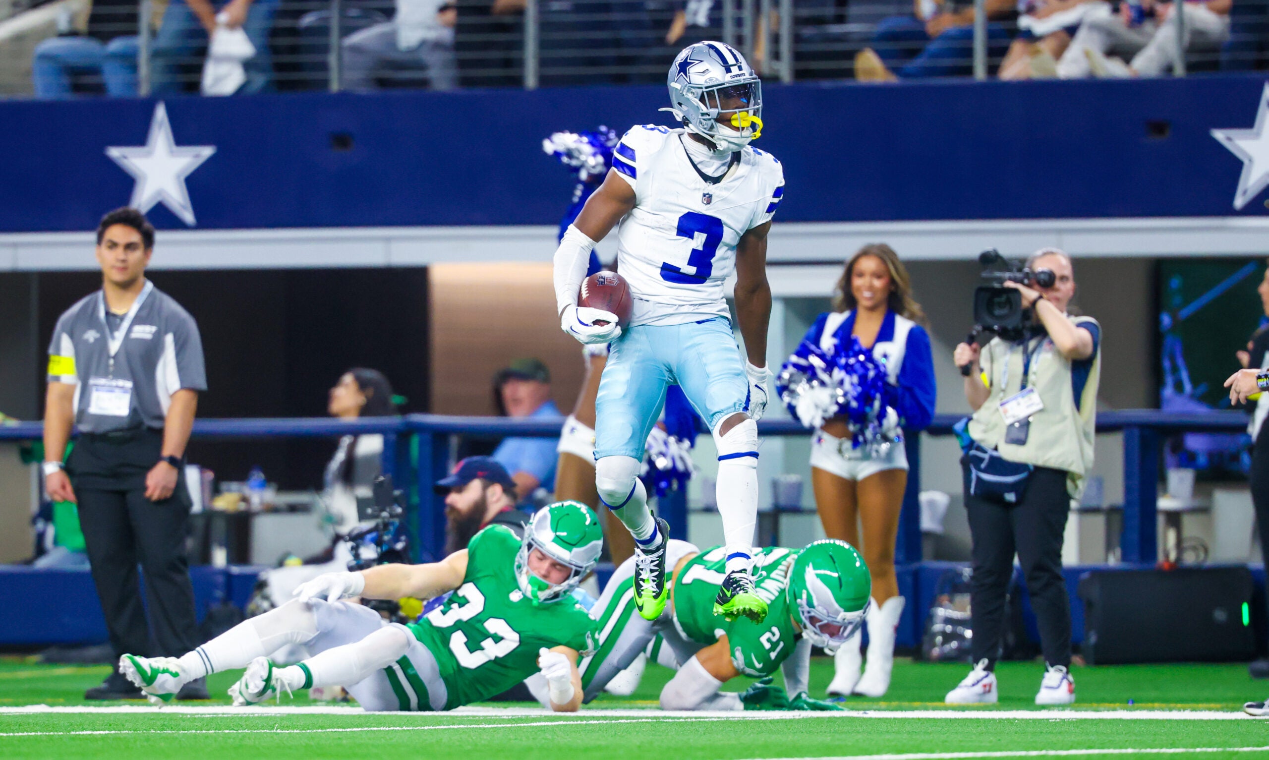 Nov 23, 2025; Arlington, Texas, USA; Dallas Cowboys wide receiver George Pickens (3) reacts after making a catch over Philadelphia Eagles cornerback Cooper DeJean (33) and Philadelphia Eagles safety Sydney Brown (21) during the game at AT&T Stadium.